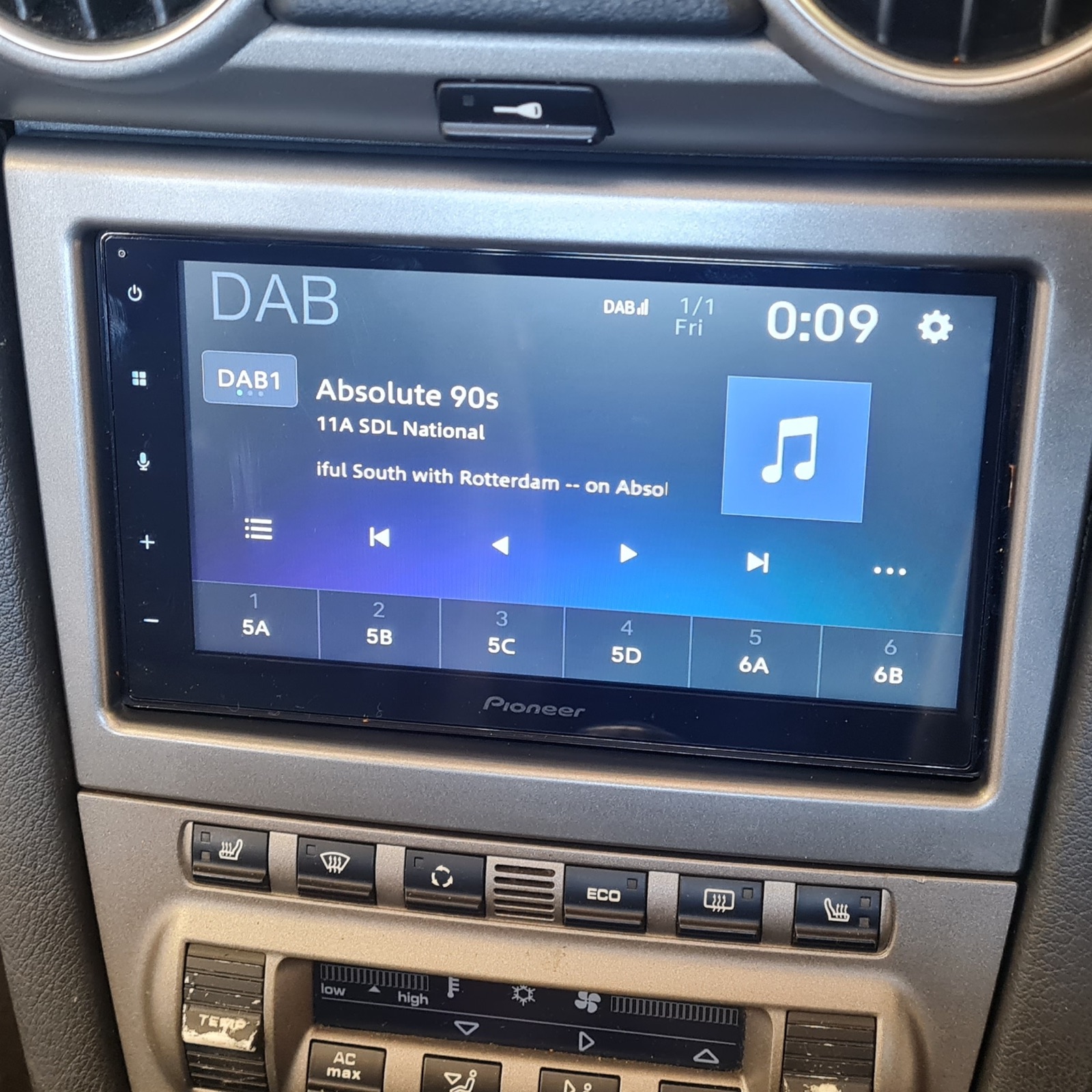 A Pioneer DAB head unit fitted into a silver dashboard, showing a digital radio station